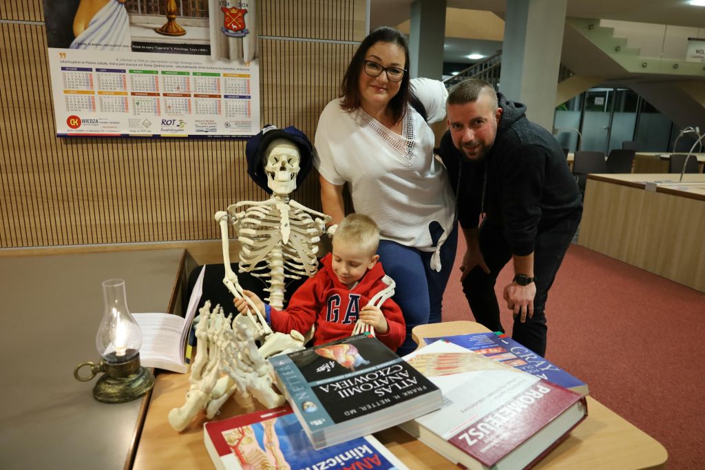 uczestnicy noc bibliotek w gmachu biblioteki w trakcie zwiedzania i zabawy.